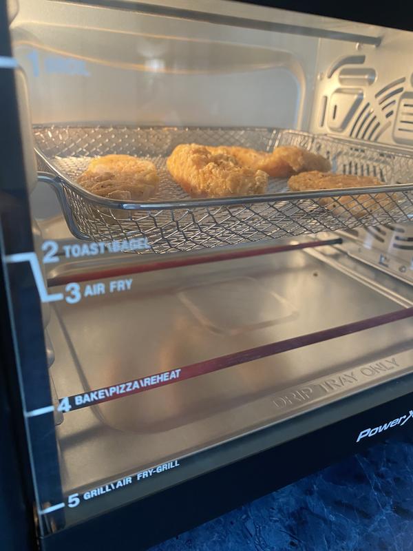 Air frying raw breaded chicken strips.