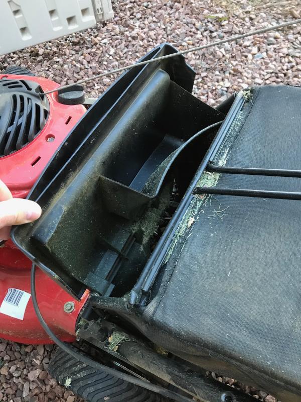 This is the V shaped object that fills with grass and dumps it’s contents if not manually scooped out before removing the catch bag.