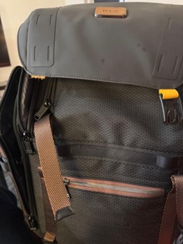 the yellow material Tumi used to attach the magnetic clip to the flap tore right off!