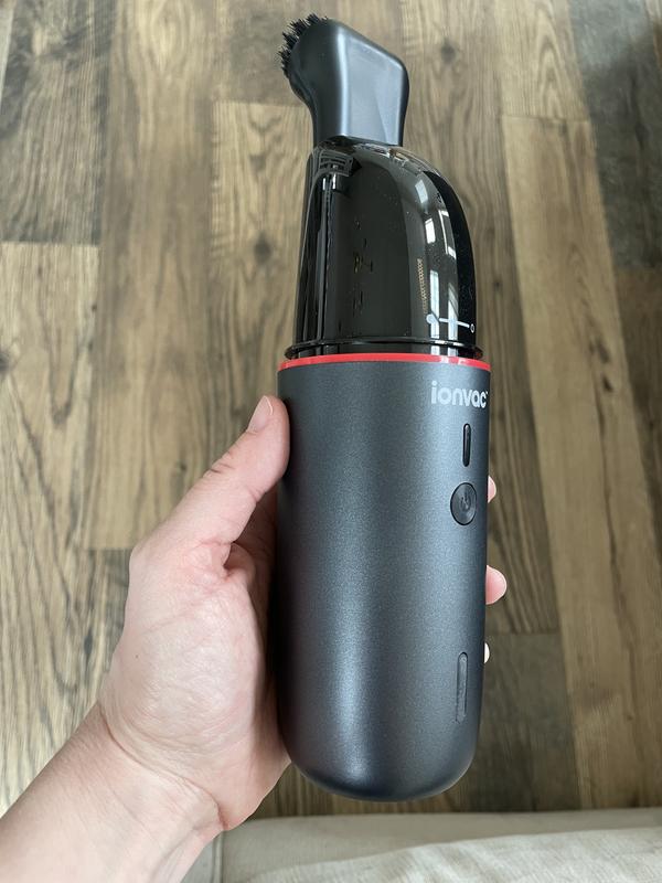 Hand vac with cover off and brush attachment.