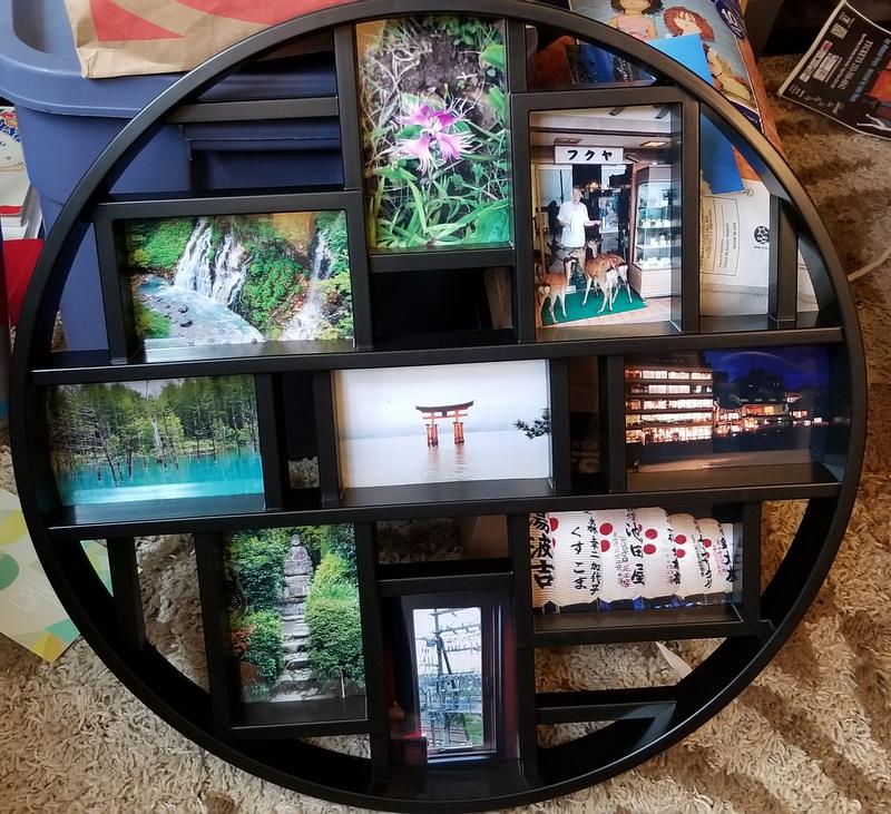 Photos arranged in the frame before hanging.