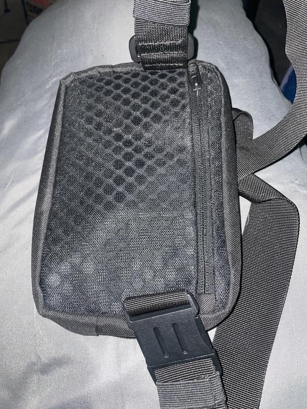 Back of bag: mesh pouch with zipper. Used for things he keeps safe