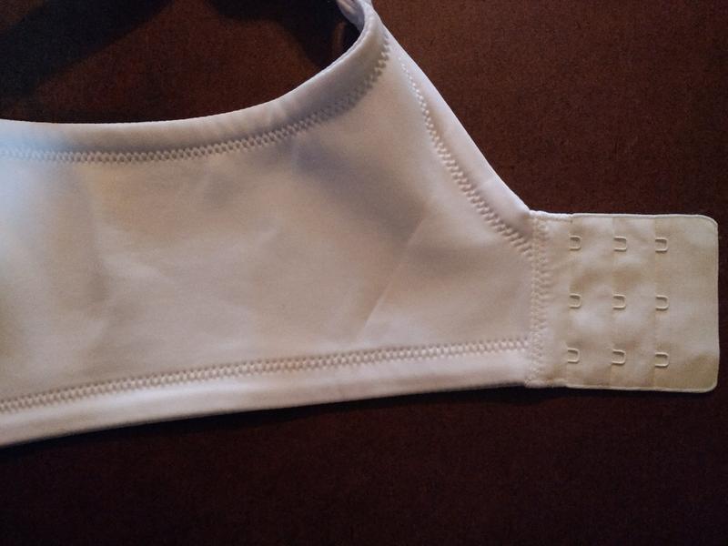 Closeup of the three hook closure and the wide back strap.  The edges are soft and comfortable.