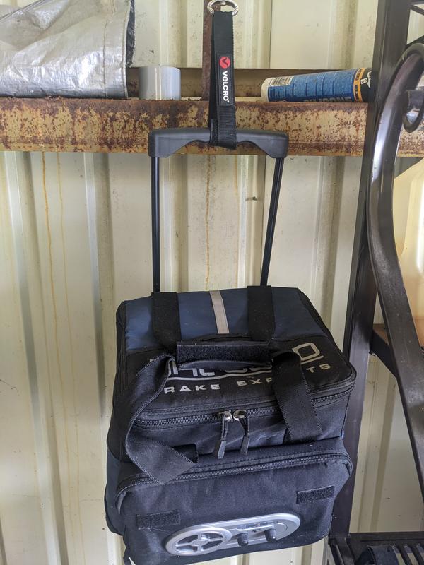 A cooler held in place with a Velcro hook.