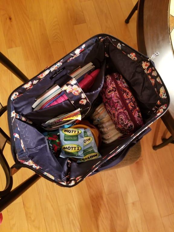 Showing it pretty full. Diapers, wipes, coloring books, tablet, etc.