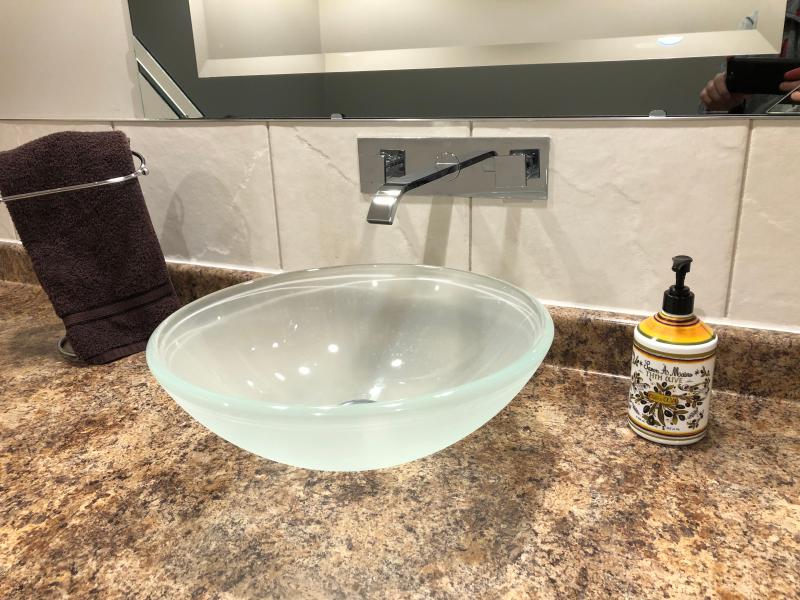 Bathroom install of vessel sink and wall mounted faucet