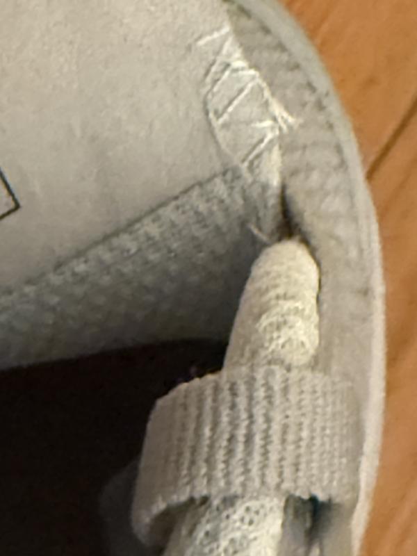 Stitching at edge of the unpadded tongue rubs away skin