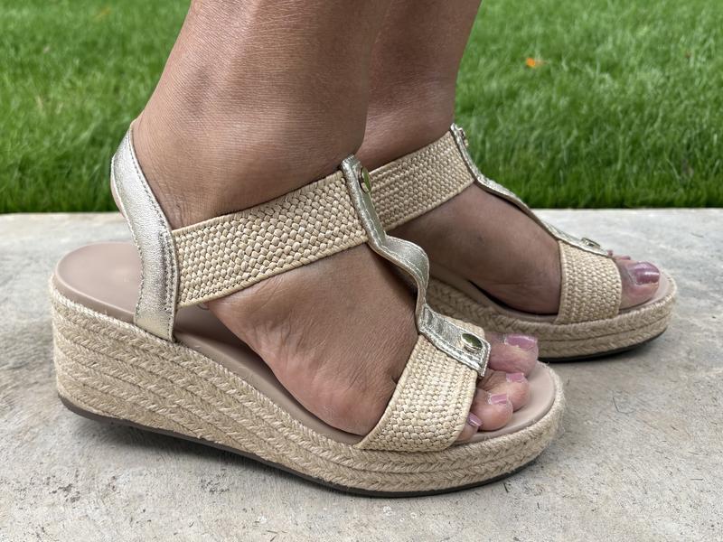 Sole is stiff, but lightweight. Upper strap is stretchy, but supportive.