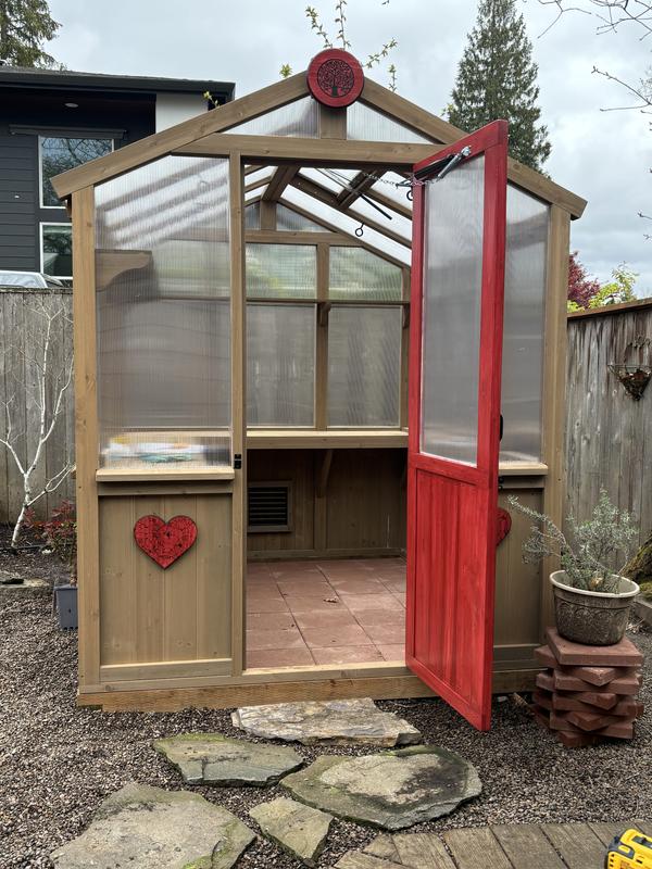 With red paver floor and stained door.