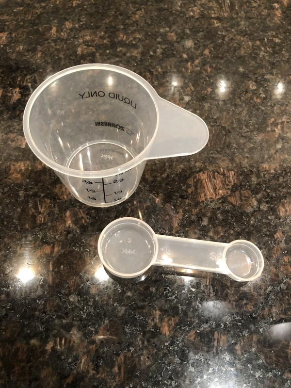 It comes with a liquid measuring cup and measuring spoon!