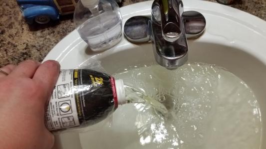 Pouring into the clogged drain.