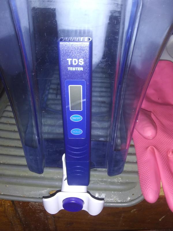 The TDS tester that came with the Pitcher "does not" fit in the holder space. The tester Does work though. The testers are sold seperate & pricey. So I'm glad that I received one.
