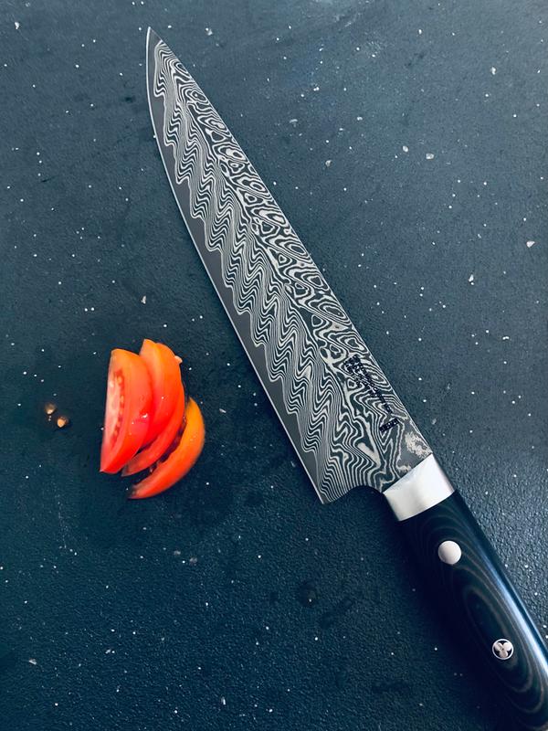 The 8 inch chefs knife with some tomatoes.